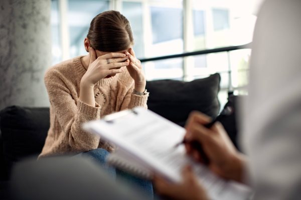 depressed-woman-having-psychotherapy-session-doctor-s-office-2-scaled
